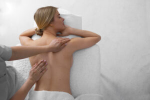 woman getting back massage from masseur