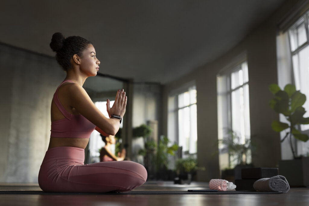 full shot woman meditating indoors